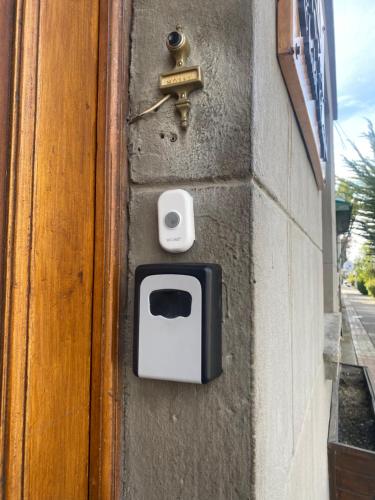 a door with a dog box on the side of a building at CHALET CHAPITAL Punta Arenas in Punta Arenas