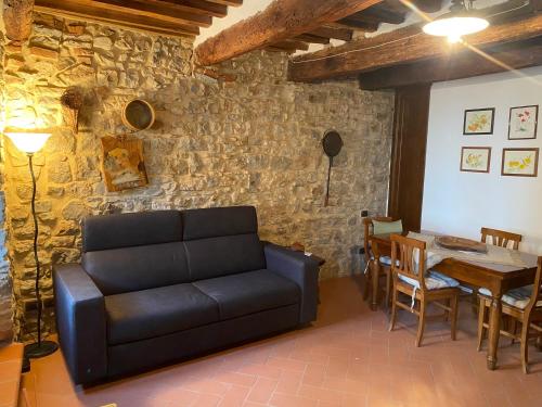 a living room with a couch and a table at Finestra sulla Val D'Orcia in Campiglia dʼOrcia
