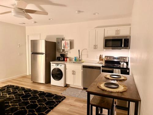 a kitchen with a refrigerator and a table in it at Azure Casita in Tempe