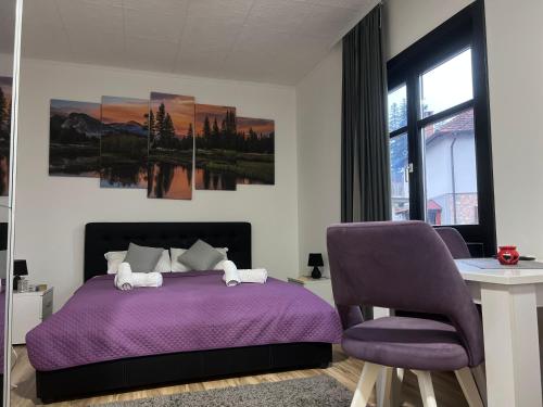 a bedroom with a purple bed and a purple chair at Restoran,,Vuk,, Tršić in TrÅ¡iÄ‡