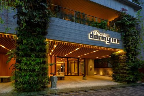 a building with a sign on the front of it at Dormy Inn Premium Ginza - Natural Hot Spring in Tokyo