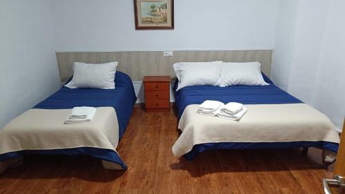 a room with two beds with towels on them at Casas Rurales Villa Vicenta in Alcalá del Júcar