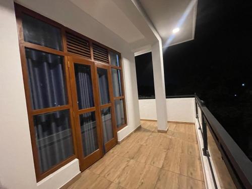 an empty room with large windows and a wooden floor at EL Bethel House in Wattala