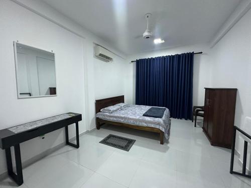 a room with two beds and a mirror in it at EL Bethel House in Wattala