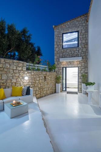a living room with a couch and a stone wall at Dion Villa Zakynthos Greece in Zakynthos
