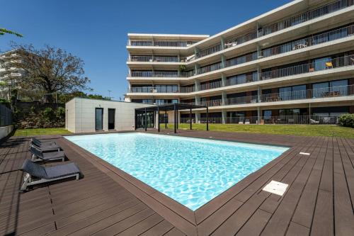 a large swimming pool in front of a building at Antas Park Concept Lifestyle With Pool in Porto