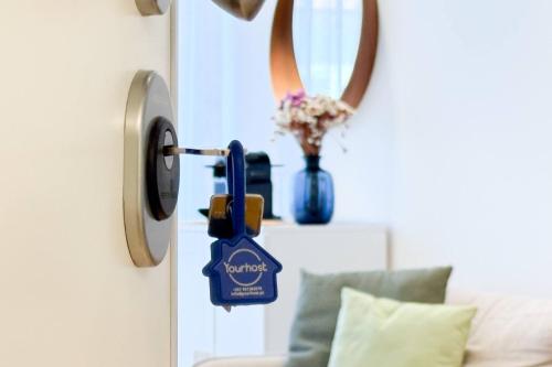 a door lock on a door with a vase of flowers at Antas Park Concept Lifestyle With Pool in Porto