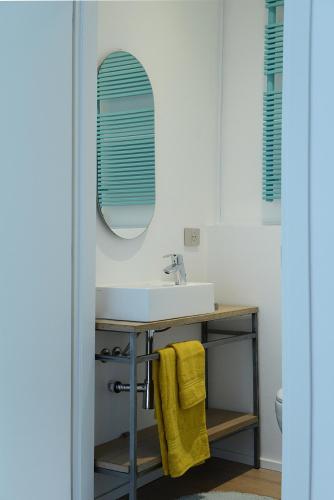 a bathroom with a sink and a mirror at Rhapsody on the Lake in Lezzeno