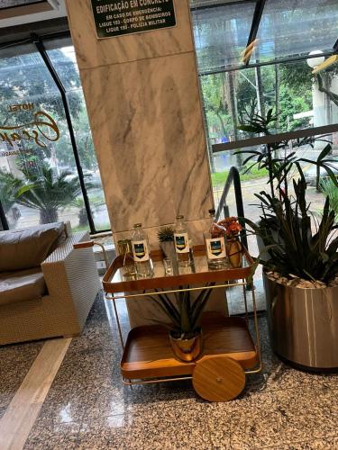 a living room with a table with glasses on it at Hotel Oscar Gold Savassi in Belo Horizonte