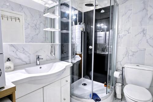 a bathroom with a shower and a toilet and a sink at Paris & Disney - 5 mins from Train Station - Champs Harmony in Champs-sur-Marne
