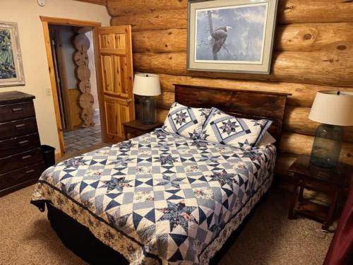 a bedroom with a bed in a log cabin at Katherine Lake Lodge in Hazelhurst