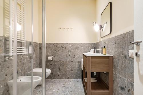 a bathroom with a toilet and a sink and a shower at Piccinni 133 in Bari