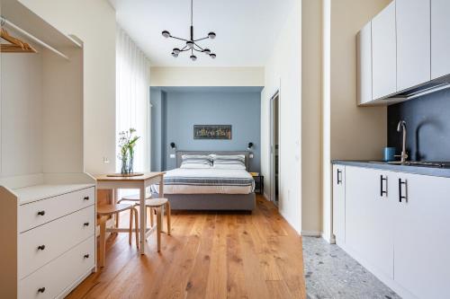 a kitchen with a bed and a table in a room at Piccinni 133 in Bari