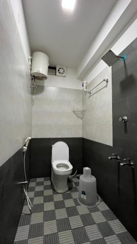 a bathroom with a toilet and a sink at Gravity Groups Golden Residency in Puducherry Airpoert