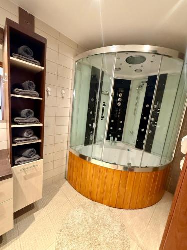 a large shower in a bathroom with a large mirror at Vallikraavi Old Town Apartment in Tartu