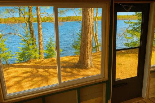 a window view of a lake from a cabin at Gresham Shores - Lil' Sunfish - PET FRIENDLY in Arbor Vitae