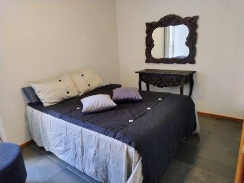 a bedroom with a bed with a mirror on the wall at Apartamento 3 quarto Alto Bueno in Goiânia