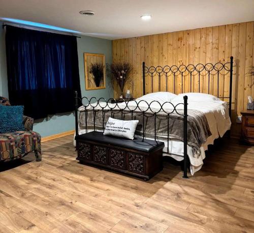 a bedroom with a bed and a chair in it at Brandy Bay Hideaway: Pet Friendly Retreat in Arbor Vitae