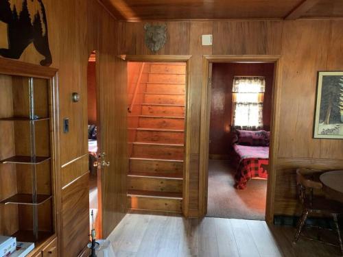 a room with wooden walls and a room with a door at Gresham Shores - Big Dipper - PET FRIENDLY in Arbor Vitae