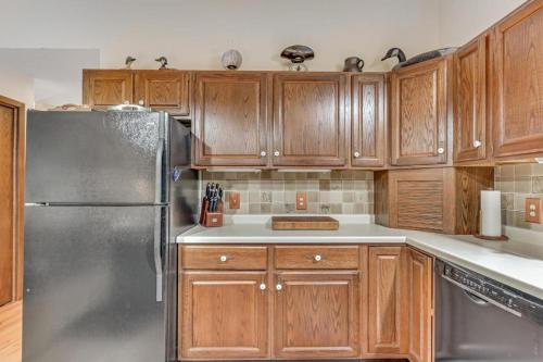 a kitchen with wooden cabinets and a stainless steel refrigerator at Loonsight in Minocqua