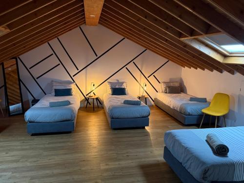 a room with three beds in a attic at B&C Furnas House in Furnas