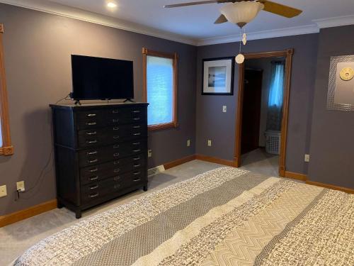 a bedroom with a bed and a television on a dresser at Lilly Pad Landing in Hazelhurst