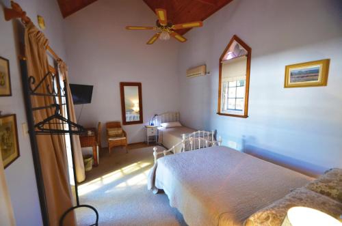 a bedroom with a bed and a ceiling fan at RoseMoore Bed & Breakfast in Perth