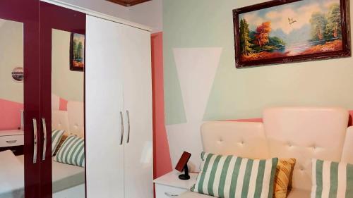 a room with a chair and a painting on the wall at Stairway to heaven in Shkodër