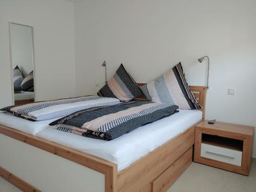 a bed with two pillows on top of it at Ferienwohnung Hagebutte in Bad Bocklet