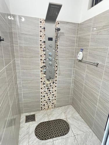 a bathroom with a shower with a shower head at Maison Sika in Zogbégan