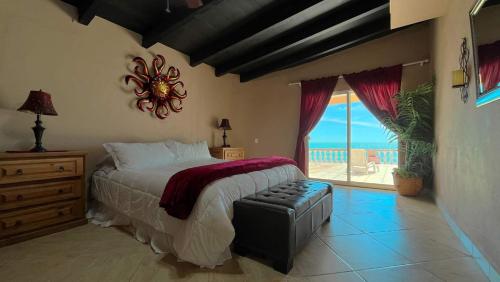 a bedroom with a bed and a view of the ocean at Recently Updated Beachfront Home Casa Neblina in Puerto Peñasco