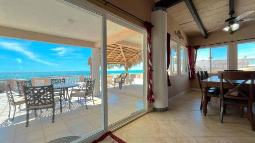 a dining room with a view of the ocean at Recently Updated Beachfront Home Casa Neblina in Puerto Peñasco
