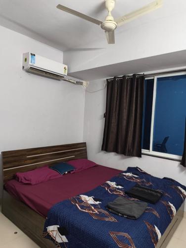 a bedroom with a bed and a ceiling fan at Rahatani pimple Saudagar 2bhk in Chinchwad