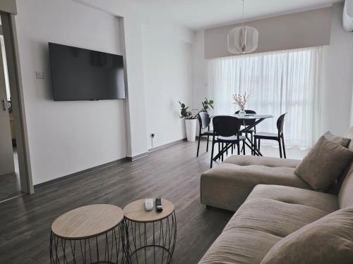 a living room with a couch and a table at Beach apartments in Limassol