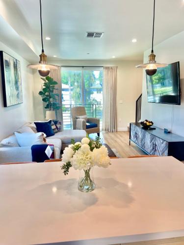 a living room with a vase of flowers on a table at New Luxe 3B 3Bath Townhouse in Sherman Oaks
