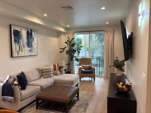 a living room with a couch and a table at New Luxe 3B 3Bath Townhouse in Sherman Oaks