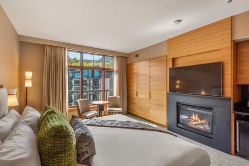 a hotel room with a bed and a fireplace at Ski-In Ski-Out Resort Studio Steps from Slopes in Snowmass Village