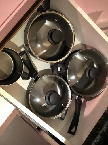 a group of pots and pans on a shelf at Studio 406 Paranagua in Paranaguá