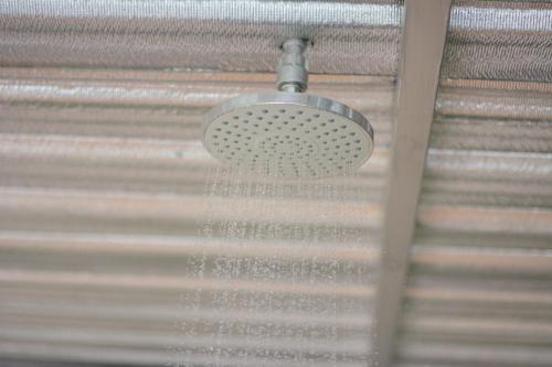 a shower with water coming out of a ceiling at Baan Boom Boxes Eco Friendly Resort in Mae Nam