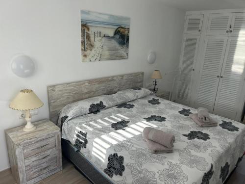 a bedroom with a bed with a comforter on it at Can Fede in Cala Tarida