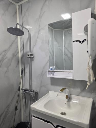 a bathroom with a white sink and a mirror at goderdzi booking in Goderdzi