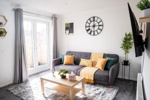 a living room with a couch and a table at Modern Luxurious Apartment with Balcony in Shenley Church End