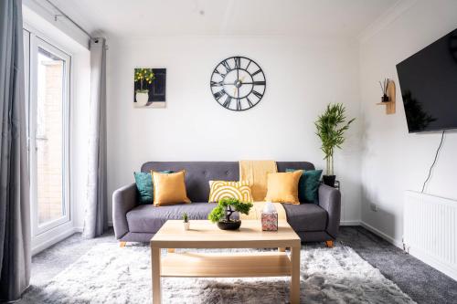 a living room with a couch and a table at Modern Luxurious Apartment with Balcony in Shenley Church End