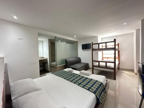 a bedroom with a bed and a bunk bed at Hotel Via 45 Centro in Medellín