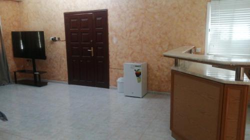 a room with a small refrigerator and a television at House Estrella - 11 in Al Ain