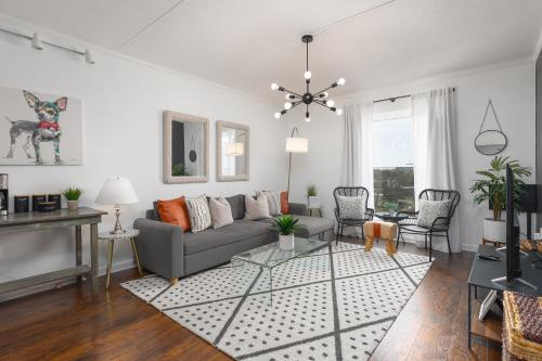 a living room with a couch and a table at Home to the Stars on Music Row with Pool and Free Parking in Nashville