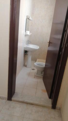 a bathroom with a toilet and a sink at House Estrella - 11 in Al Ain