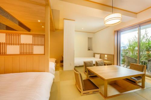 a room with a table and a bed and a dining room at Dormy Inn Premium Ginza - Natural Hot Spring in Tokyo