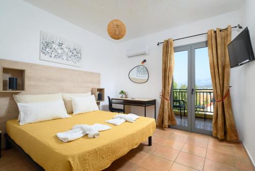 a bedroom with a bed with towels on it at Hersonissos Villas in Hersonissos