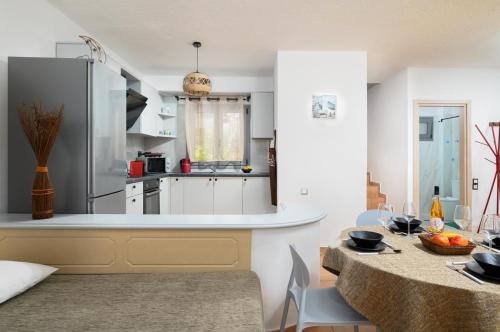 a kitchen and dining room with a dining table and a kitchen at Hersonissos Villas in Hersonissos